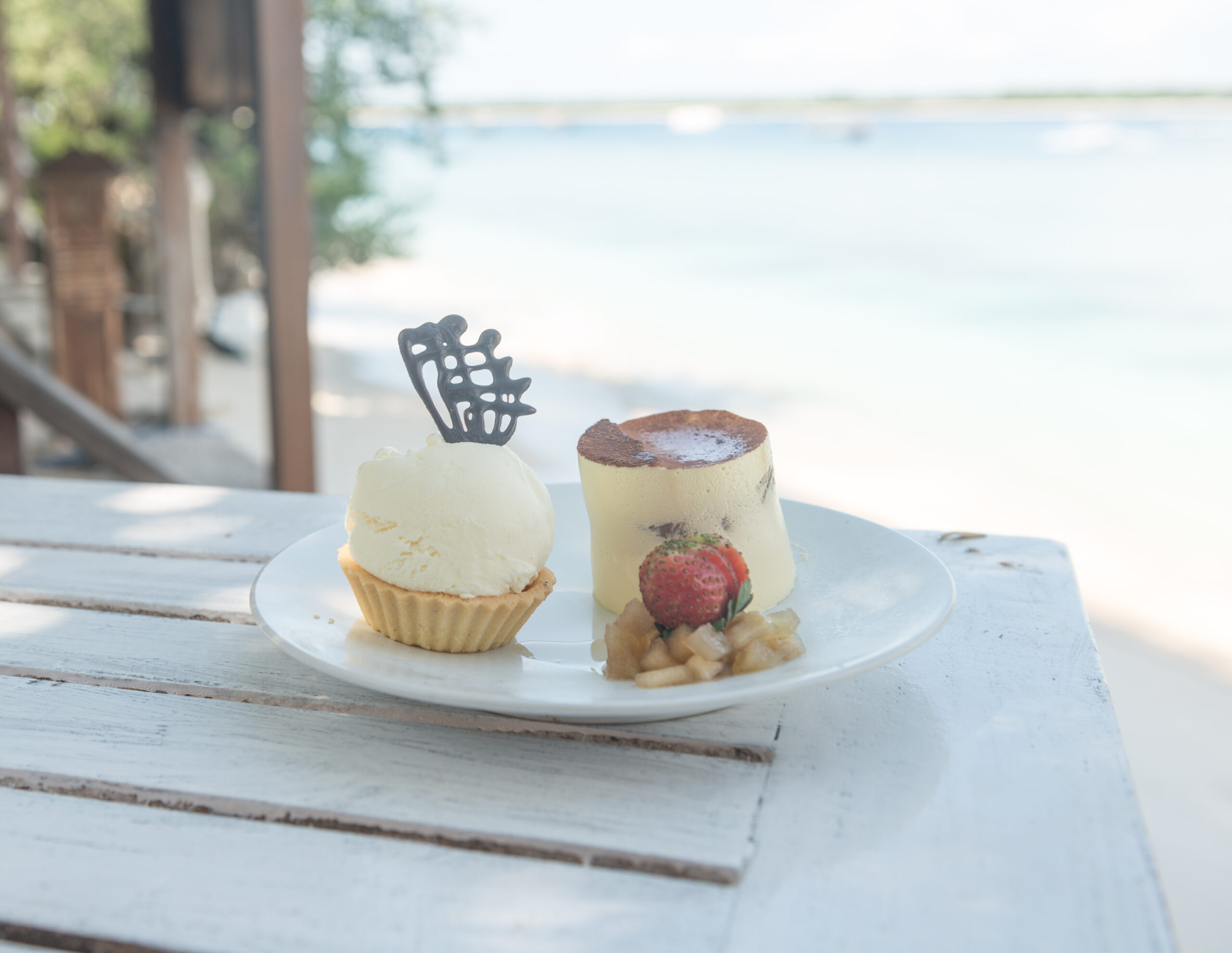 Delicious ice cream and chockolate desserts at beach table